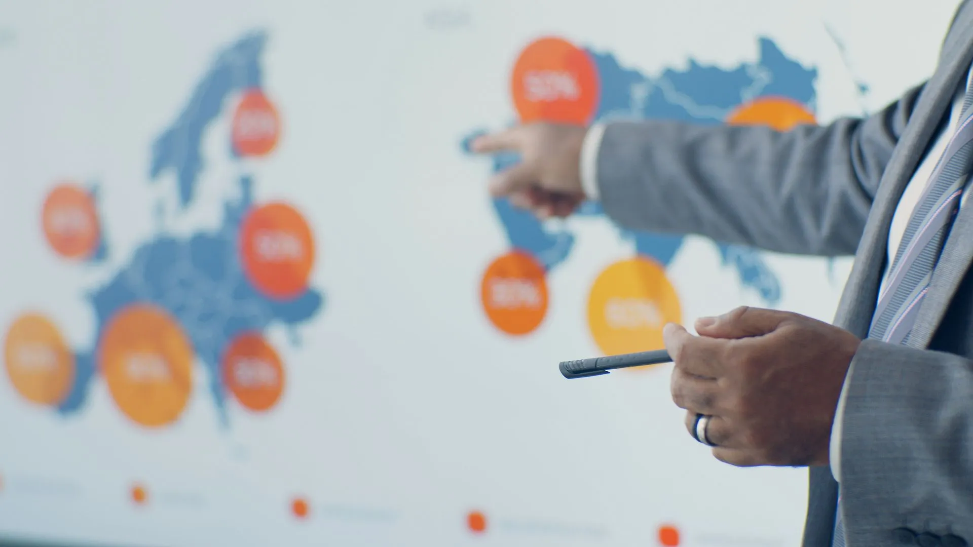 A planner pointing at a regional coverage map on a presentation screen