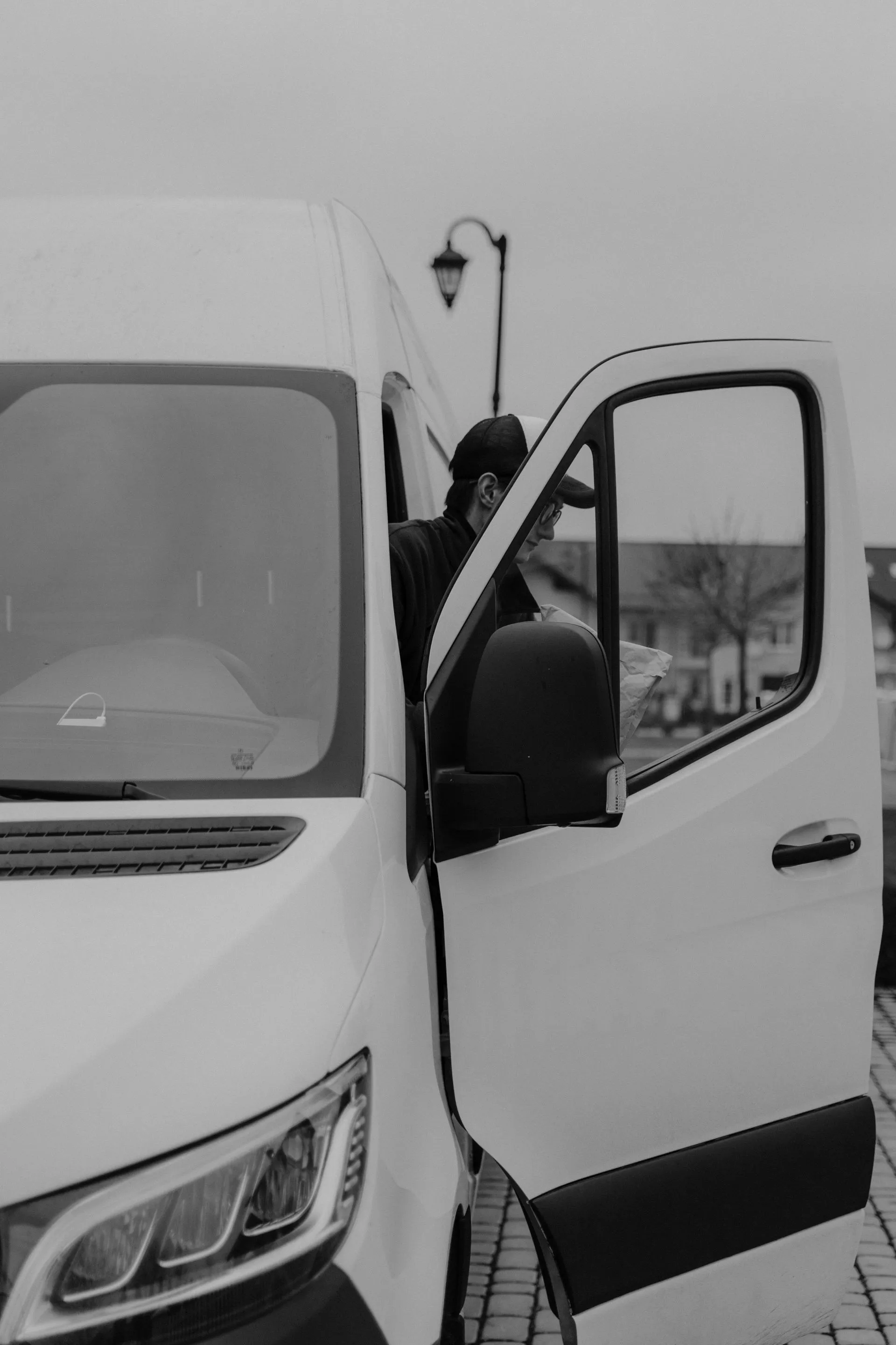 Driver stepping out of a van to make a delivery