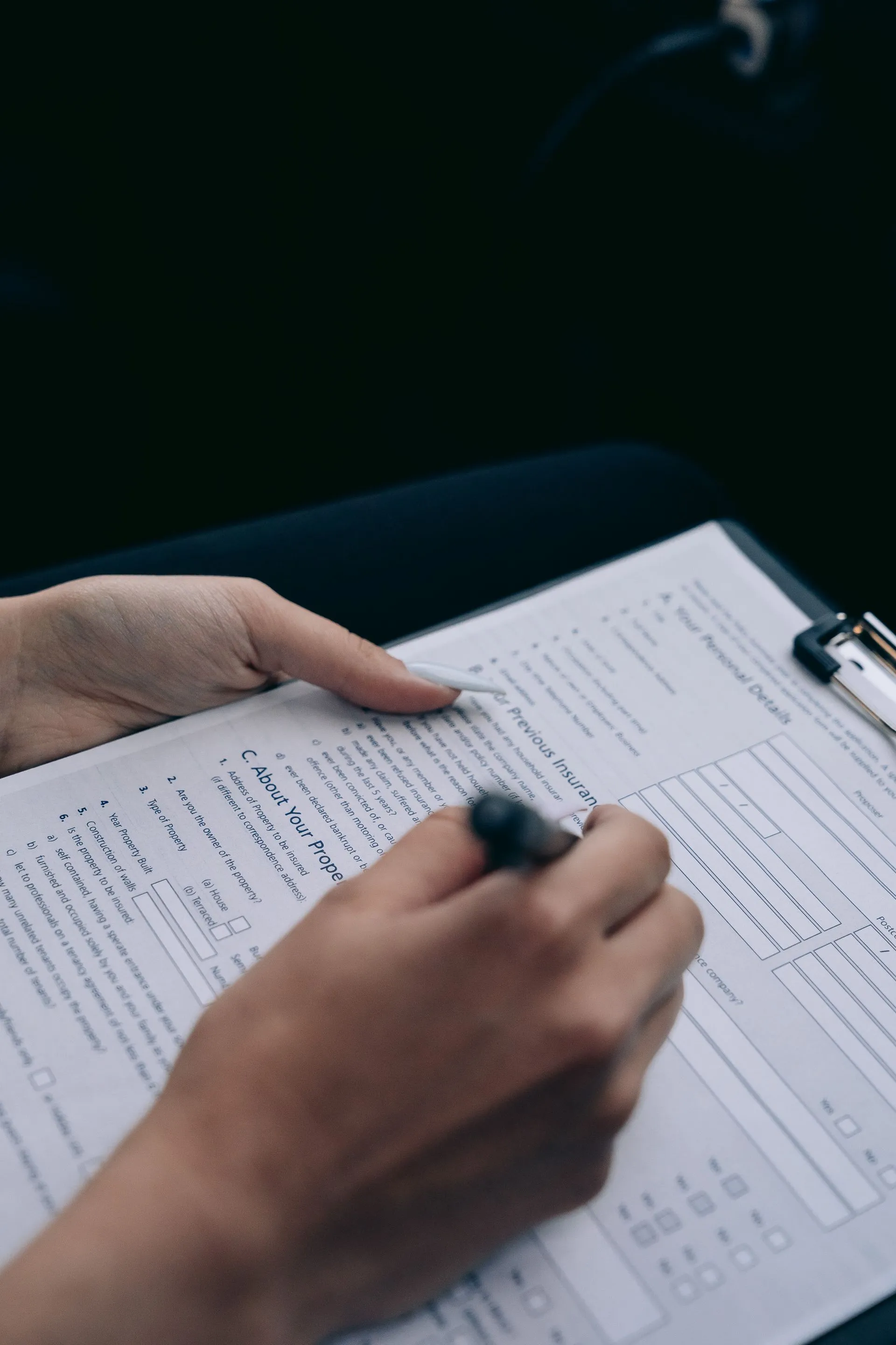 Close-up of hands completing delivery paperwork