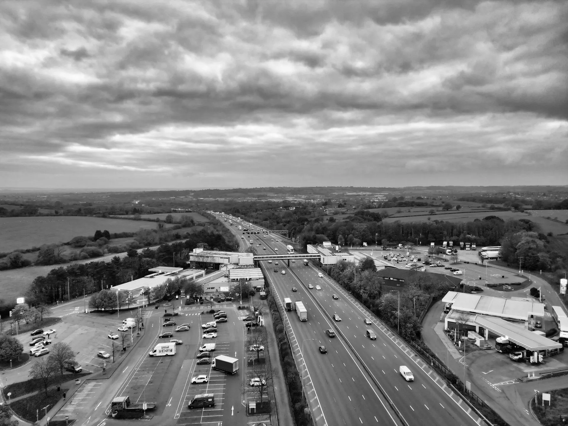 Aerial view of the M1 motorway with a service station, showing the road network vehicles actually travel